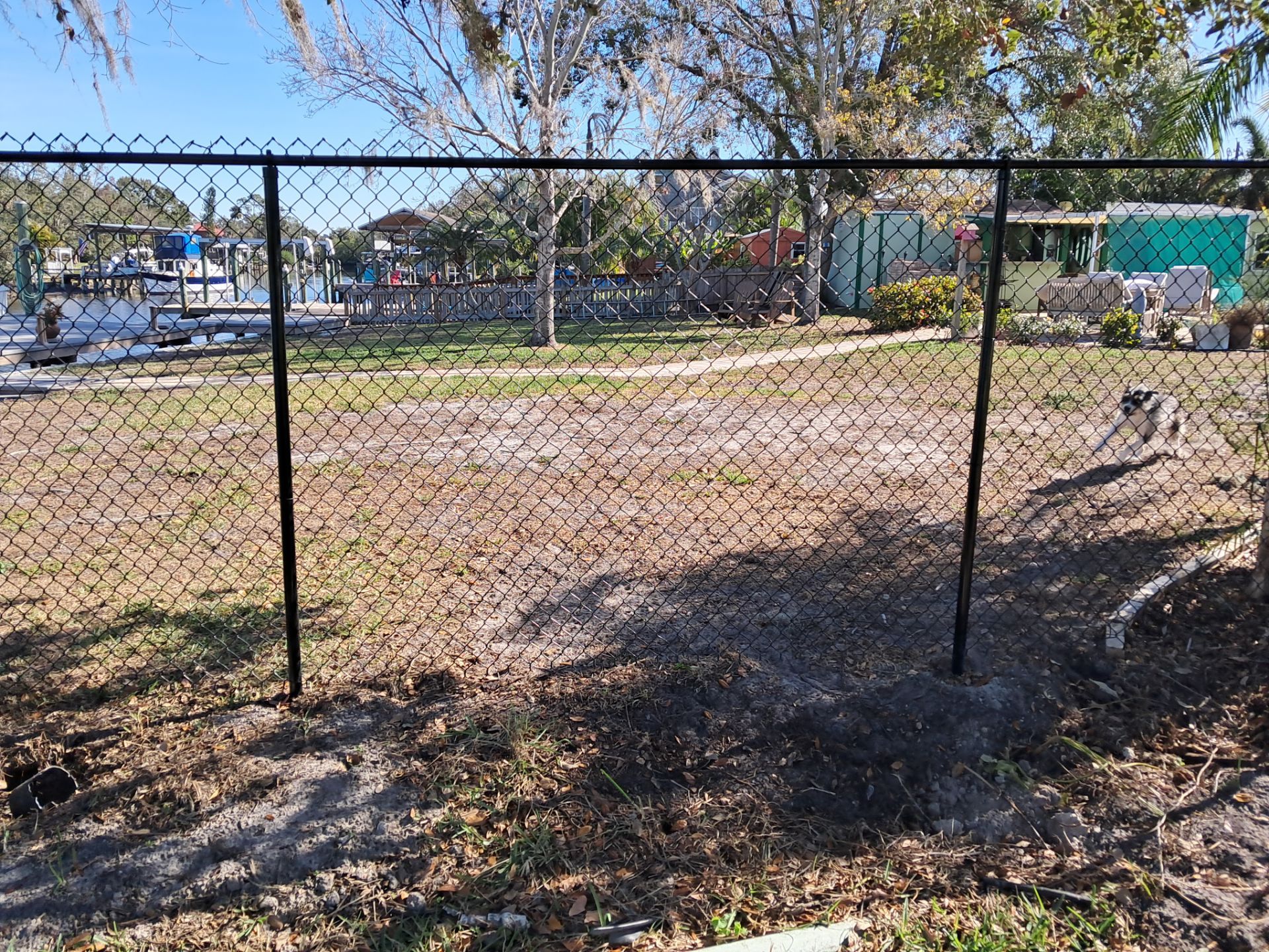 Black Vinyl Chain-Link Fence Installation by WhatAFence – The Perfect Blend of Style and Functionality!